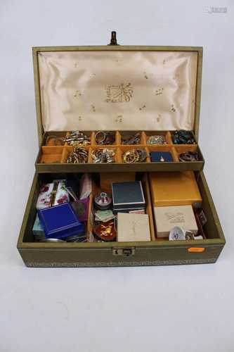 A leather clad jewellery box and contents, to include a gilt...