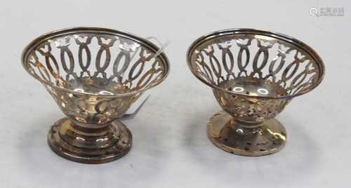 A pair of George V silver bonbon dishes, each of pierced cir...