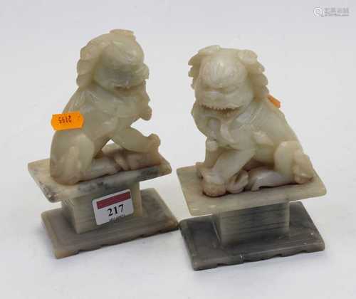 A pair of polished hardstone figures, each carved as a Dog o...