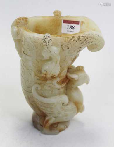 A carved and polished hardstone libation cup / jug, having a...