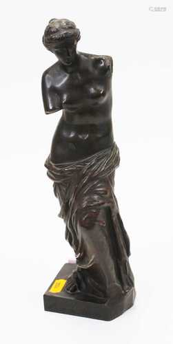 A bronzed figure of a classical semi-nude maiden, in standin...