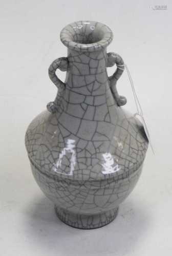 A Chinese crackle-glaze vase, having a slender neck with twi...