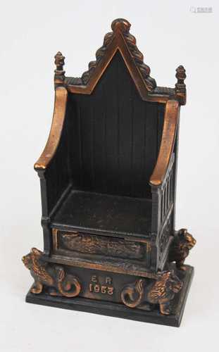 A cast metal money-box in the form of the Coronation throne ...