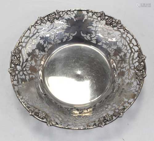 A modern silver bowl, of shaped circular form, the border re...