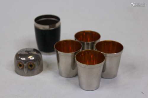 A set of four chrome travelling spirit cups, in owl case, h....