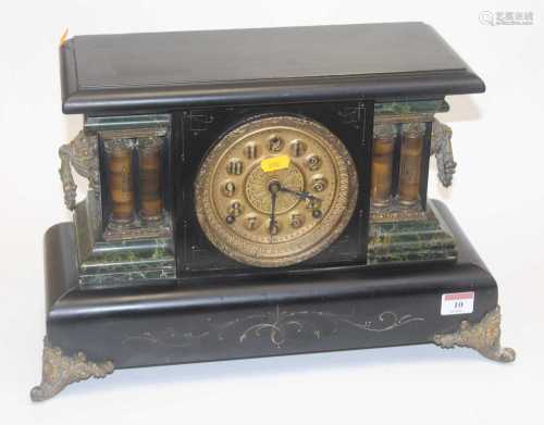 A late 19th century faux black slate and marble mantel clock...