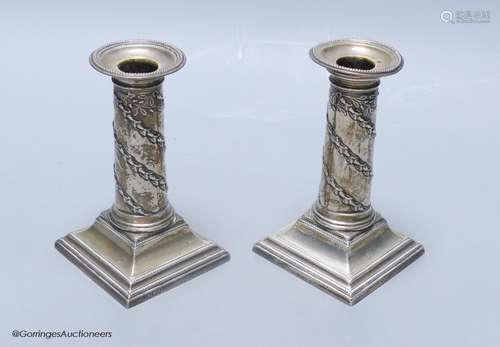 A matched pair of late Victorian silver dwarf candlesticks, ...