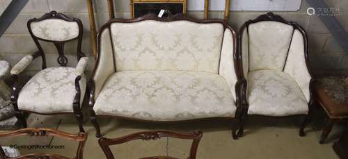 A late Victorian mahogany three piece salon suite