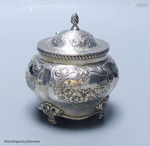 An Edwardian embossed silver bombe shaped tea caddy, William...