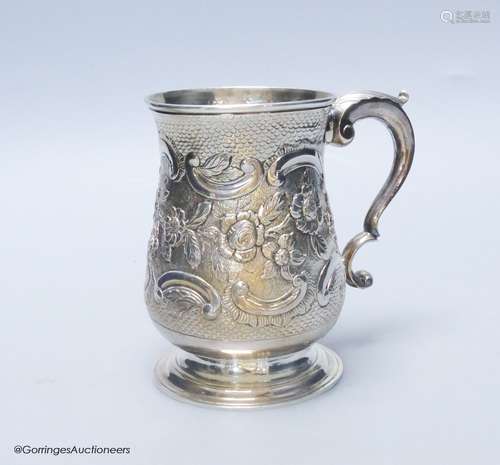 A George III silver baluster mug, with later embossed decora...