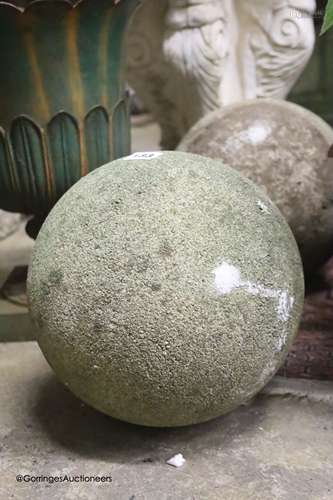 A pair of reconstituted stone spherical garden ornaments, he...