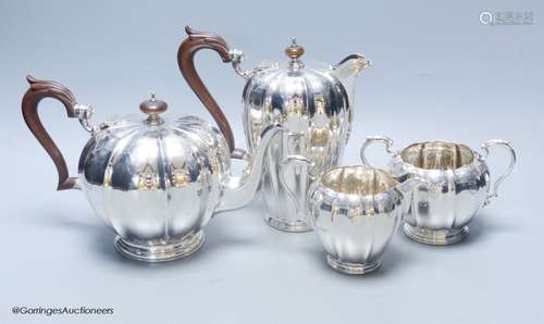 A George V engraved fluted silver four piece silver tea set ...