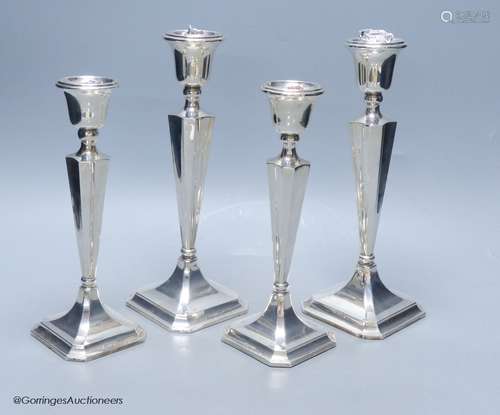 Two graduating pairs of George V silver candlesticks, James ...