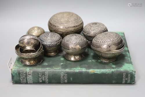 A collection of Malay Straits white metal circular betel nut...