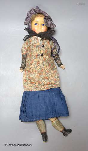 A wax composition doll, In early clothing, one leg detached ...