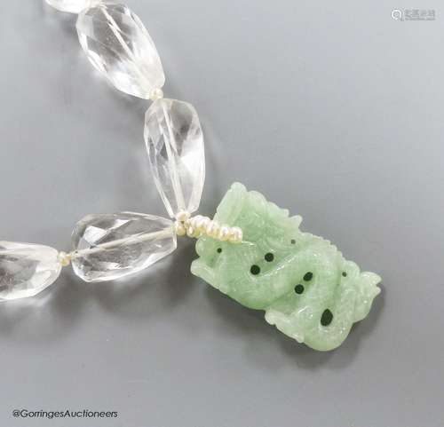 A shaped facet cut rock crystal necklace, with carved jade p...