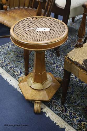 A William IV walnut and bird's eye maple caned seated adjust...