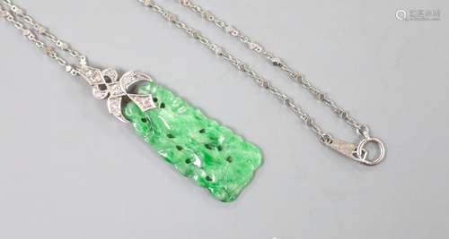 A 1920's white metal and diamond mounted carved jade pendant...