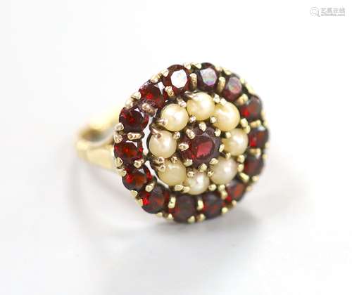 A modern 9ct gold, garnet and split pearl set circular clust...