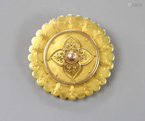 A Victorian yellow metal circular brooch, with central folia...