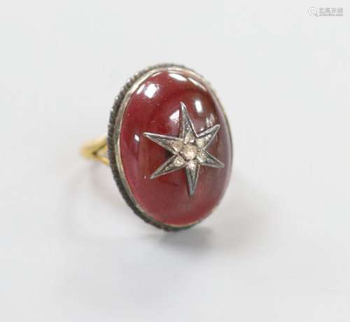 A 19th century yellow and white metal, oval cabochon garnet ...