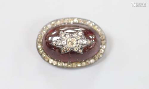 A 19th century yellow and white metal, oval cabochon garnet,...