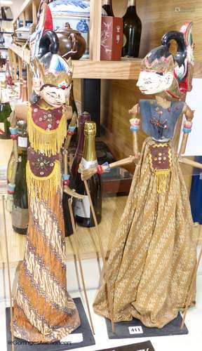 Two Indonesian stick puppets and a book relating to stick pu...