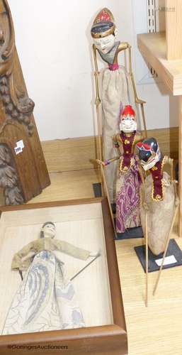 Three Indonesian stick puppets and another framed puppet, ta...