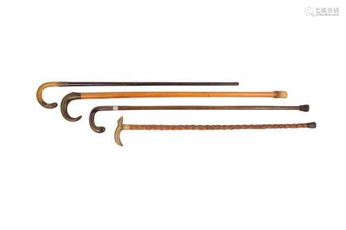 λ FOUR WALKING STICKS WITH RHINOCEROS HORN HANDLES.