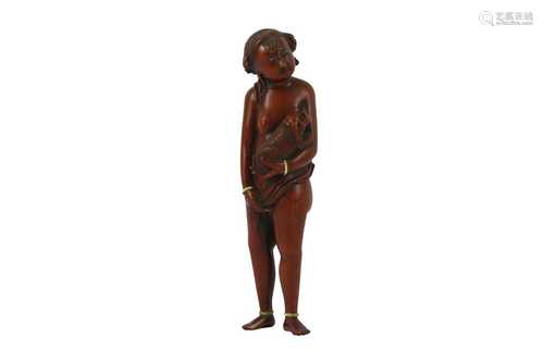 λ A BOXWOOD CARVING OF A YOUNG GIRL WITH IVORY INLAY.