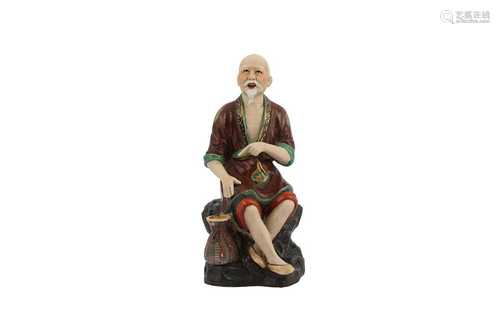 A CHINESE GLAZED SEATED FIGURE.