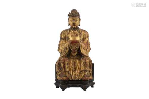 A CHINESE GILT-LACQUER WOOD FIGURE OF AN ATTENDANT.