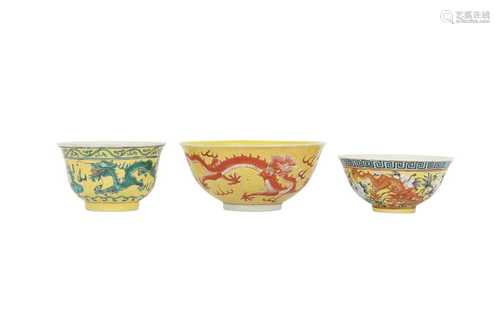 THREE CHINESE YELLOW-GROUND 'DRAGON' BOWLS.