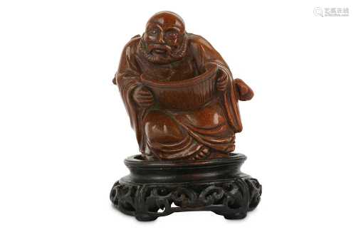 A CHINESE CARVED TIGER'S EYE FIGURE OF A SAGE.
