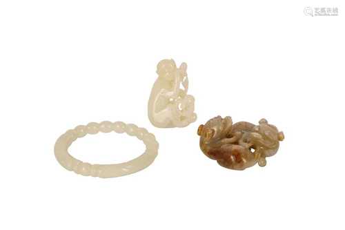 TWO CHINESE PALE CELADON JADE CARVINGS AND A BANGLE.