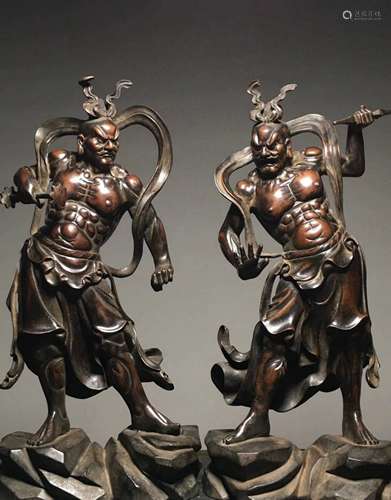 A pair of bronze statues of strong men