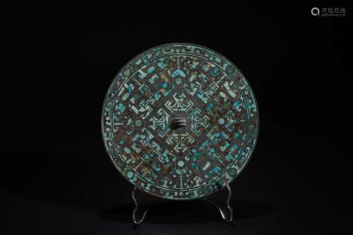 A bronze mirror with gold and silver inlaid with turquoise a...