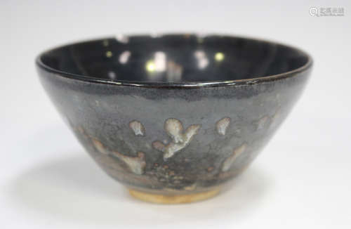 A Chinese dark brown glazed pottery bowl, Song dynasty style...