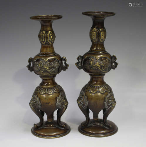 A pair of Japanese brown patinated bronze candlesticks, Meij...