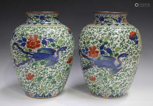 A pair of Chinese wucai porcelain jars, Transitional style b...