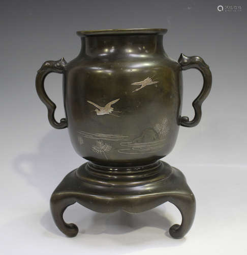 A Japanese silver inlaid brown patinated bronze two-handled ...