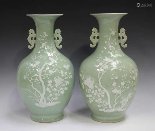 A pair of Chinese celadon glazed and white slip decorated po...