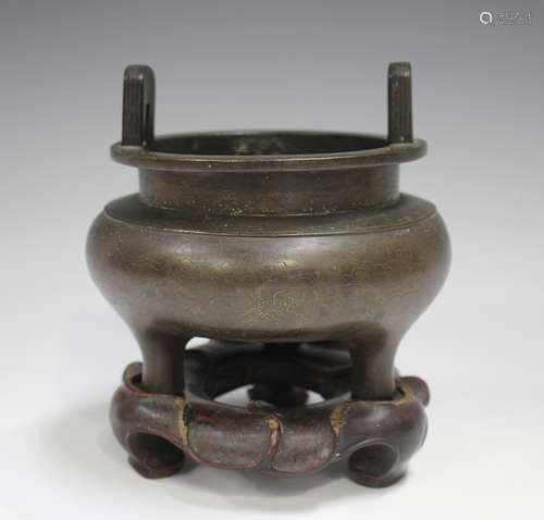 A Chinese brown patinated bronze tripod censer, Qing dynasty...