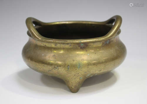 A Chinese polished bronze tripod censer, Qing dynasty, of ci...