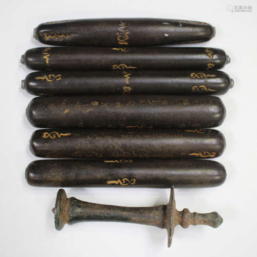 A group of six Thai takrut tubular amulets, each hardwood bo...