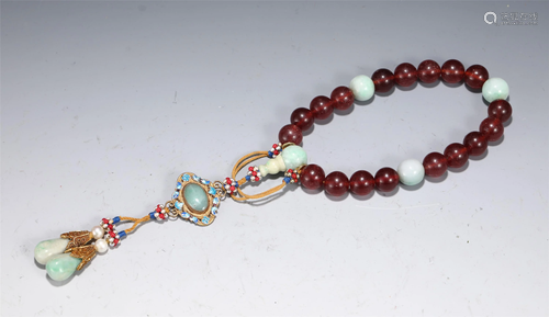 A STRING OF RED HARD-STONES PRAYER BEADS