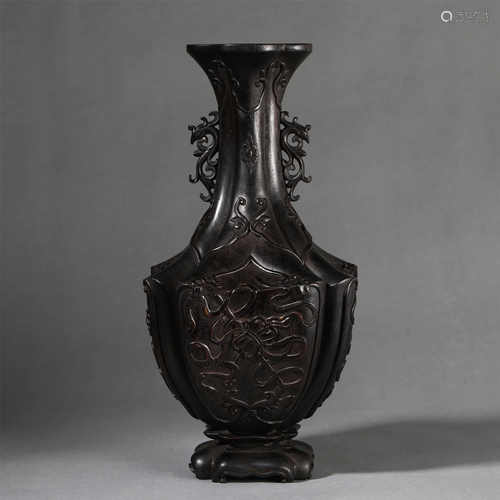 A HARDWOOD CARVED VASE WITH DOUBLE HANDLES