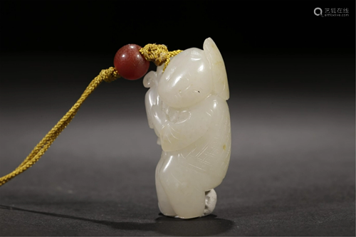 A WHITE JADE CARVED KID CARRYING LOTUS