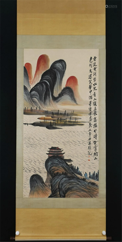 A CHINESE SCROLL PAINTING OF MOUNTAINS AND PAVILIONS