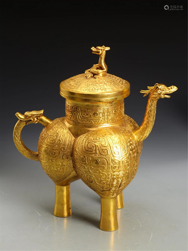 A GILT BRONZE BEAST FACE TRIPOD VESSEL